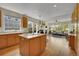 Bright kitchen open to the living room features natural light, wood floors, island, and an inviting fireplace at 20591 E Weaver Ave, Aurora, CO 80016