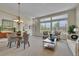 Bright living area with a chandelier, expansive windows, and an open layout at 20591 E Weaver Ave, Aurora, CO 80016