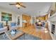 Inviting living room and kitchen combo featuring hardwood floors, ample cabinetry, and a cozy breakfast nook at 20591 E Weaver Ave, Aurora, CO 80016