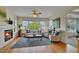 Cozy living room with a fireplace, hardwood floors, and lots of natural light at 20591 E Weaver Ave, Aurora, CO 80016