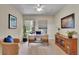 Well-lit home office space with a large desk, comfortable chair, and stylish decor at 20591 E Weaver Ave, Aurora, CO 80016