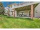 Relaxing covered patio features comfortable seating, views of the spacious backyard, and shade at 20591 E Weaver Ave, Aurora, CO 80016