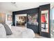 Bedroom with open wall to the kitchen, expansive views from the large windows, and tasteful art at 3100 E Cherry Creek South Dr # 1403, Denver, CO 80209