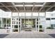 Modern building entrance featuring glass doors and a steel support structure at 3100 E Cherry Creek South Dr # 1403, Denver, CO 80209