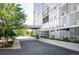 Modern building exterior with a covered drive and lush landscaping at 3100 E Cherry Creek South Dr # 1403, Denver, CO 80209