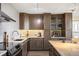 Modern kitchen featuring stainless steel appliances, tile backsplash, and granite countertops at 3100 E Cherry Creek South Dr # 1403, Denver, CO 80209