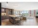 Bright open kitchen with island, breakfast bar, modern lighting, and hardwood floors with adjacent living area and large windows at 3100 E Cherry Creek South Dr # 1403, Denver, CO 80209