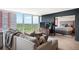 Open living room with expansive windows showcasing the city view and access to the adjacent bedroom at 3100 E Cherry Creek South Dr # 1403, Denver, CO 80209