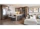 Open living space with a kitchen island, seating, and stainless steel appliances at 3100 E Cherry Creek South Dr # 1403, Denver, CO 80209