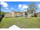 View of a spacious backyard with a small storage shed and a house featuring a sliding glass door at 7820 Tejon St, Denver, CO 80221