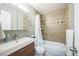 Bathroom with modern vanity, tiled shower, and sleek fixtures, offering a spa-like experience in neutral tones at 7820 Tejon St, Denver, CO 80221