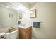 Cozy bathroom with vanity sink, mirrored cabinet, toilet, and decorative accents that create a calming atmosphere at 7820 Tejon St, Denver, CO 80221
