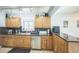 Kitchen with granite countertops, a stainless steel dishwasher, and wood cabinetry at 7820 Tejon St, Denver, CO 80221