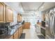 Open kitchen featuring granite countertops, stainless steel appliances, and a seamless flow to the living area at 7820 Tejon St, Denver, CO 80221