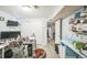 Well-lit office space with modern desk, storage, and closet, perfect for productivity with a comfortable chair and pet bed at 7820 Tejon St, Denver, CO 80221