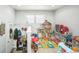 Bright playroom with ample natural light, featuring colorful alphabet rug and an assortment of engaging toys and play structures at 7820 Tejon St, Denver, CO 80221
