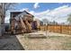 Backyard features wooden staircase and deck leading to a fenced-in yard at 308 Inca St, Denver, CO 80223
