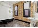 Vintage-style bathroom with exposed brick, a clawfoot tub, and pedestal sink at 308 Inca St, Denver, CO 80223