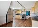 Kitchen with stainless steel appliances, light wood cabinetry, and dark hardwood floors at 308 Inca St, Denver, CO 80223