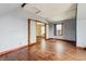 Sun filled living room with original hardwood flooring and neutral paint at 308 Inca St, Denver, CO 80223