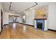 Bright living room featuring wood floors, a fireplace, and an open layout at 308 Inca St, Denver, CO 80223