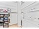 Bright laundry room with concrete pillar and white appliances at 2000 Arapahoe St # 503, Denver, CO 80205