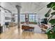 Open-concept living space with hardwood floors, large windows, and exposed beams, seamlessly connecting to the kitchen at 2000 Arapahoe St # 503, Denver, CO 80205