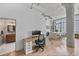 Spacious work area leading to kitchen and bathroom, exposed beams, and city views through large windows at 2000 Arapahoe St # 503, Denver, CO 80205
