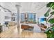 Bright, open living area features exposed brick, modern furnishings, and large windows with city views at 2000 Arapahoe St # 503, Denver, CO 80205