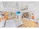 Open floor plan bedroom with stylish wooden shelving and concrete ceilings at 2000 Arapahoe St # 503, Denver, CO 80205