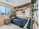 Cozy bedroom with a rustic wall accent and window seating at 4552 Crestone Peak St, Brighton, CO 80601