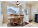 Bright dining area with wood table and chairs, plus a view to backyard at 4552 Crestone Peak St, Brighton, CO 80601