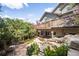 Stunning backyard featuring a multi-level deck, stone patio, rock waterfall, and lush landscaping at 600 Cascade Dr, Golden, CO 80403