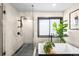 Modern bathroom featuring a glass enclosed shower with a rainfall shower head and a freestanding tub with stylish fixtures at 600 Cascade Dr, Golden, CO 80403