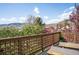 Outdoor deck with wood railings offering scenic views of trees and mountains at 600 Cascade Dr, Golden, CO 80403