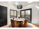 Bright dining area with a view, featuring a stylish round table and four leather chairs at 600 Cascade Dr, Golden, CO 80403