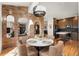 Charming dining area featuring a round table with seating, a brick accent wall, and an adjacent modern kitchen at 600 Cascade Dr, Golden, CO 80403