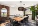Bright dining room features a wood table, black chairs, unique lighting, and a view of the surrounding landscape at 600 Cascade Dr, Golden, CO 80403