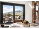 Bright dining area with a round table, deck access, and a scenic mountain view at 600 Cascade Dr, Golden, CO 80403
