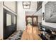 Grand foyer features soaring ceilings, rich hardwood floors, arched brick doorway, and a modern black decor at 600 Cascade Dr, Golden, CO 80403