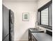 Modern laundry room features stacked washer/dryer, sleek countertop, and a window for natural light at 600 Cascade Dr, Golden, CO 80403