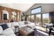 Spacious living room with modern gray walls, a white sectional, and access to a deck with mountain views at 600 Cascade Dr, Golden, CO 80403