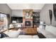 Cozy living room featuring a brick fireplace, large TV, and a comfortable seating area at 600 Cascade Dr, Golden, CO 80403