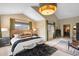 Bright main bedroom with vaulted ceiling, a seating area, and views of the outside landscape at 600 Cascade Dr, Golden, CO 80403