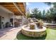 Relaxing outdoor space with multi-tiered rock waterfall, stone patio, and hot tub at 600 Cascade Dr, Golden, CO 80403