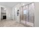 Bright bathroom with a glass shower, modern fixtures, and neutral tile design at 8814 S Winnipeg Ct, Aurora, CO 80016