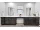 Bathroom with a double sink vanity, modern lighting, and a neutral color palette at 8814 S Winnipeg Ct, Aurora, CO 80016