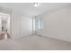 Bright bedroom with plush carpet, large window, and ample closet space at 8814 S Winnipeg Ct, Aurora, CO 80016