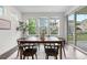 Bright dining room featuring a wood table with black chairs, big windows and sliding glass door at 8814 S Winnipeg Ct, Aurora, CO 80016