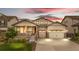 Inviting home exterior with a charming front porch, two-car garage, and manicured landscaping at 8814 S Winnipeg Ct, Aurora, CO 80016